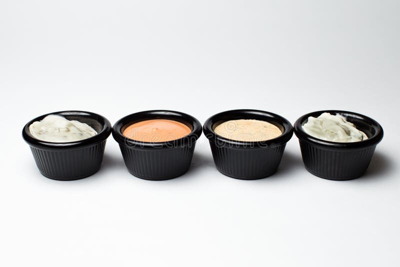 Different Sauces in Assortment in an Black Sauces Stock Photo Image