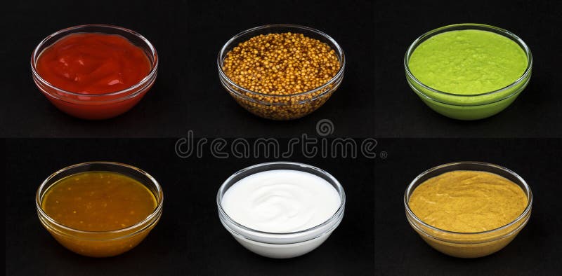 Different sauces isolated on black background