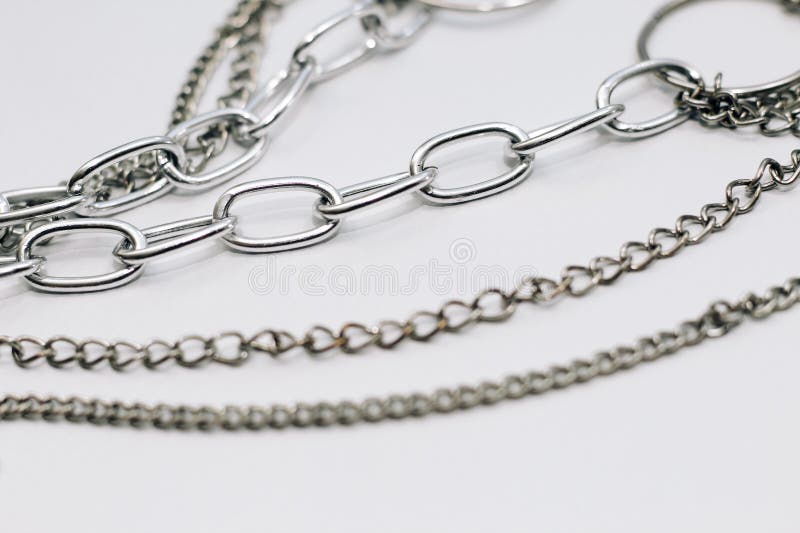 Different Silver Metal Chains on a Light Background. Stock Photo
