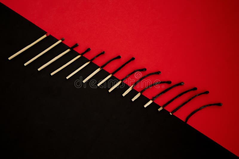 Different Stages of Match Burning Isolated on Red and Black Background