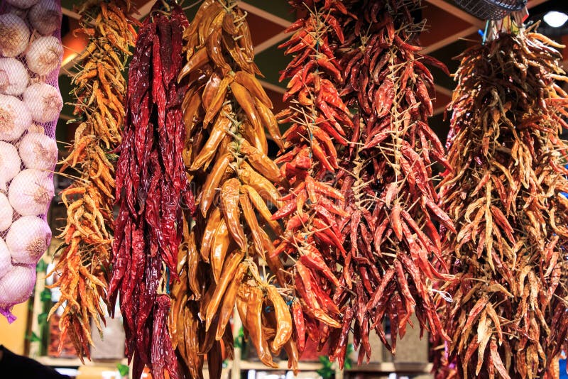 Different strips of hot peppers and chili peppers hanging from the ceiling in the Boqueria market royalty free stock photos Different strips of hot peppers and chili peppers hanging from the ceiling in the Boqueria market royalty free stock photos
