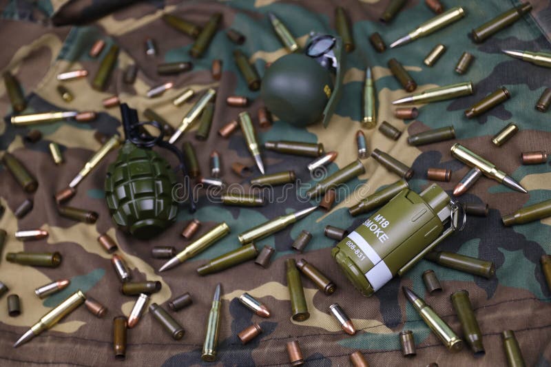 Different types of ammunition and grenades on a camouflage background. Preparing for war. Possession of weapons. Types conflict stock images, royalty-free photos and pictures