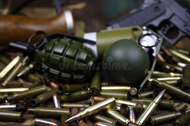 Different types of ammunition and grenades on a camouflage background. Preparing for war. Possession of weapons. Types conflict stock images, royalty-free photos and pictures