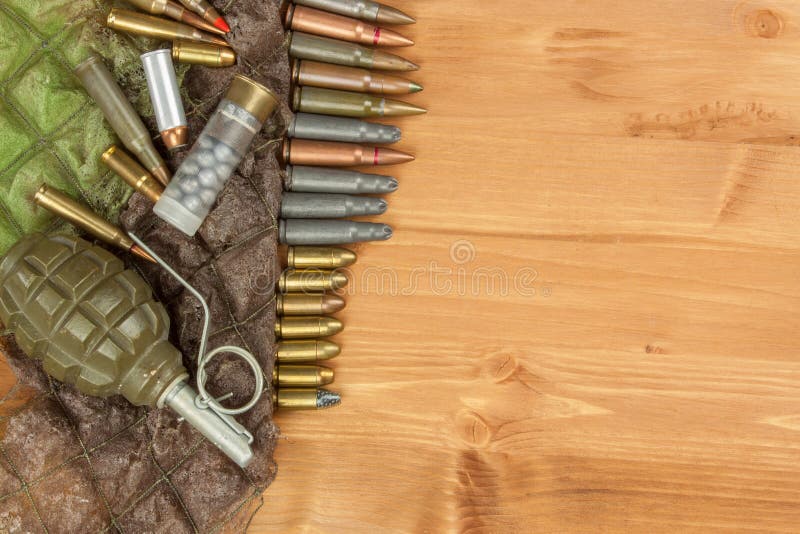 Different types of ammunition on a wooden background. Grenade and bullets. Arms trade. Types conflict stock images, royalty-free photos and pictures
