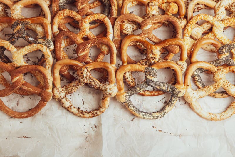 Different Types of Baked Pretzels with Seeds on a Black Background