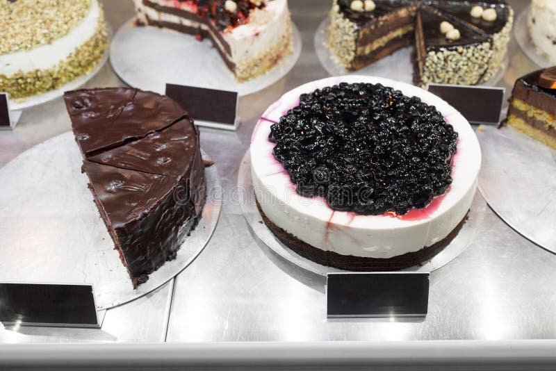 Different types of cakes in pastry shop glass display