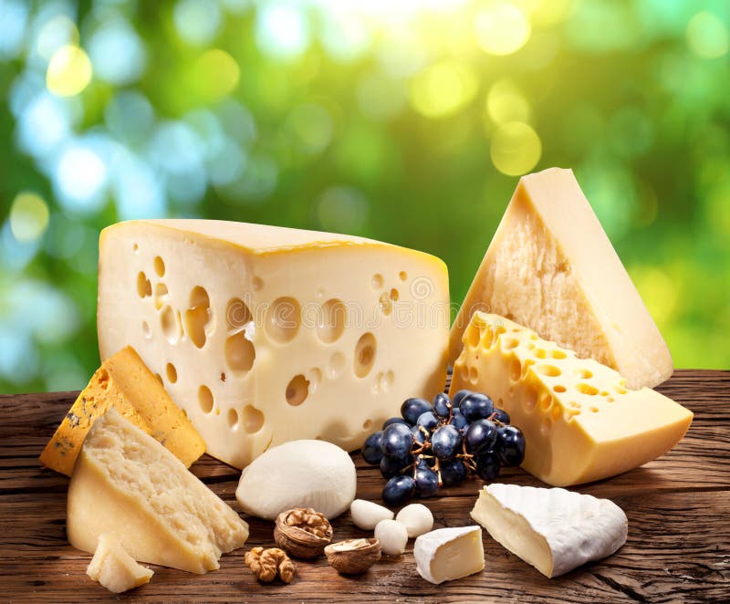 Different types of cheese over old wooden table. royalty free stock photos