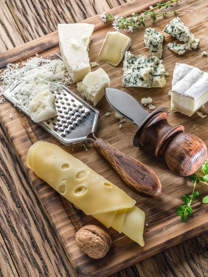 Different types of cheeses with nuts and herbs. royalty free stock photography