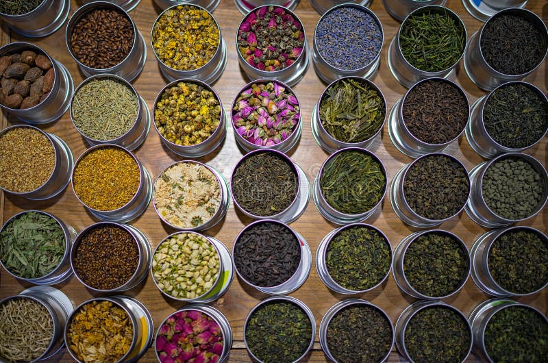 Different types of tea in round containers stock photo