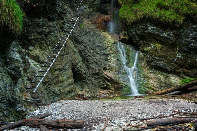 Difficul trail with ladder near the waterfall in canyon of National park Slovak paradise