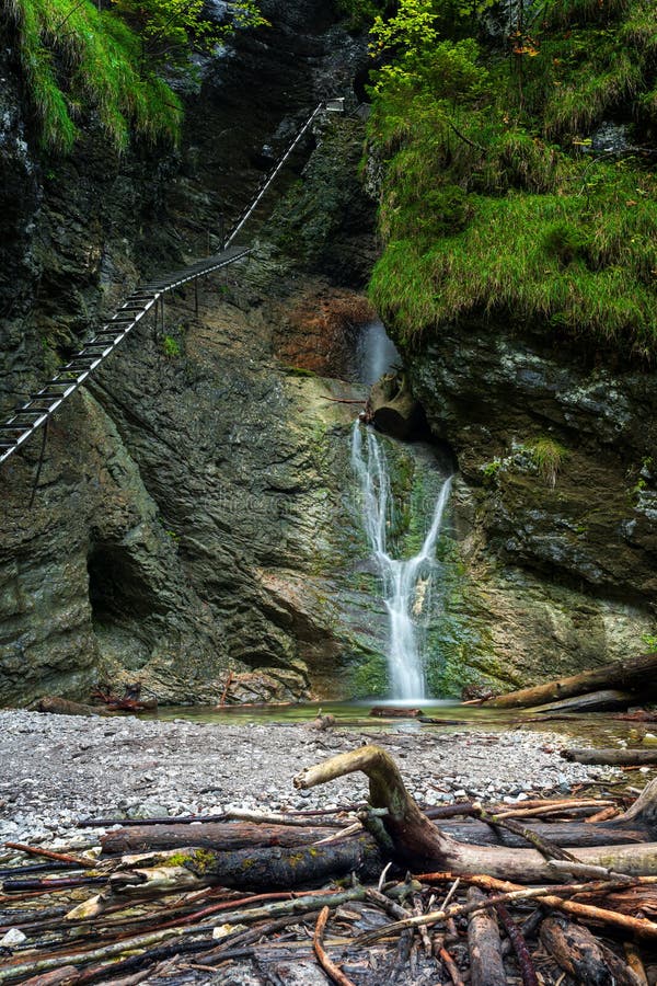 Difficul trail with ladder near the waterfall in canyon of National park Slovak paradise