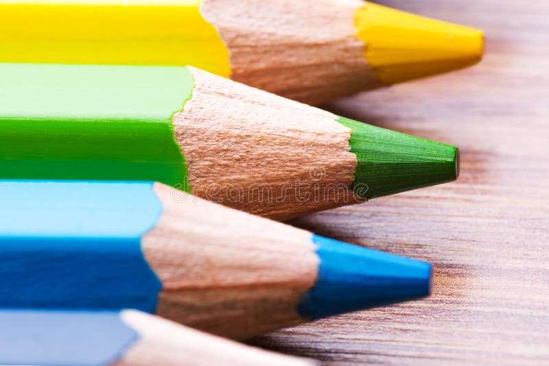 Different colored crayons on wood background. Different colored crayons on wood background