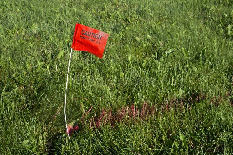 Digger Hotline Flag Buried Electrical Power Line royalty free stock photos Digger Hotline Flag Buried Electrical Power Line royalty free stock photos