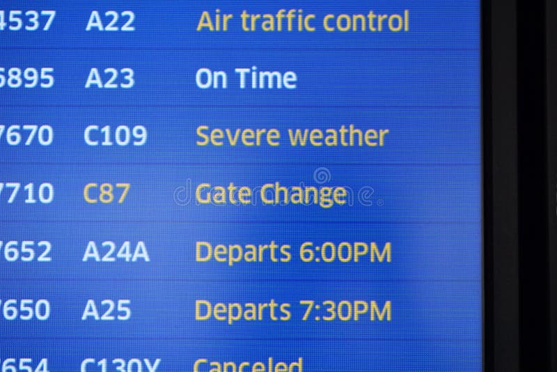 Yellow highlighted font identifies the reasons flights are canceled or delayed out of the airport.  Severe inclement weather, late aircraft arrivals posted in view for travelers.  Electronic screens in cobalt blue update with gate numbers and letters. Yellow highlighted font identifies the reasons flights are canceled or delayed out of the airport.  Severe inclement weather, late aircraft arrivals posted in view for travelers.  Electronic screens in cobalt blue update with gate numbers and letters.