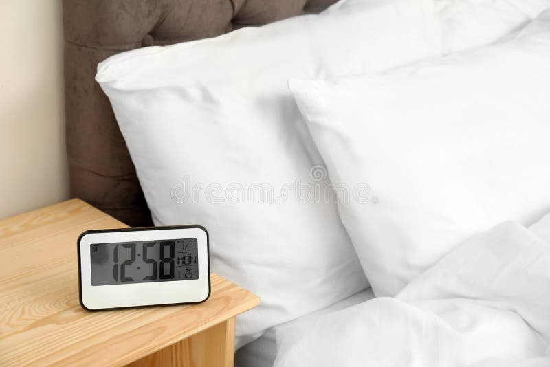 Digital Alarm Clock On Table In Bedroom Stock Photo Image