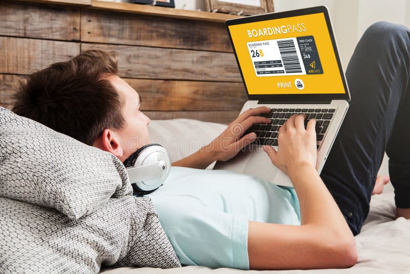 Man using a laptop computer to print flight boarding pass at home stock image Man using a laptop computer to print flight boarding pass at home stock image