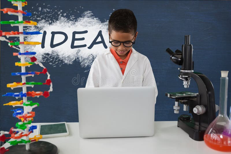Student boy at table using a computer against blue blackboard with idea text royalty free stock photos Student boy at table using a computer against blue blackboard with idea text royalty free stock photos