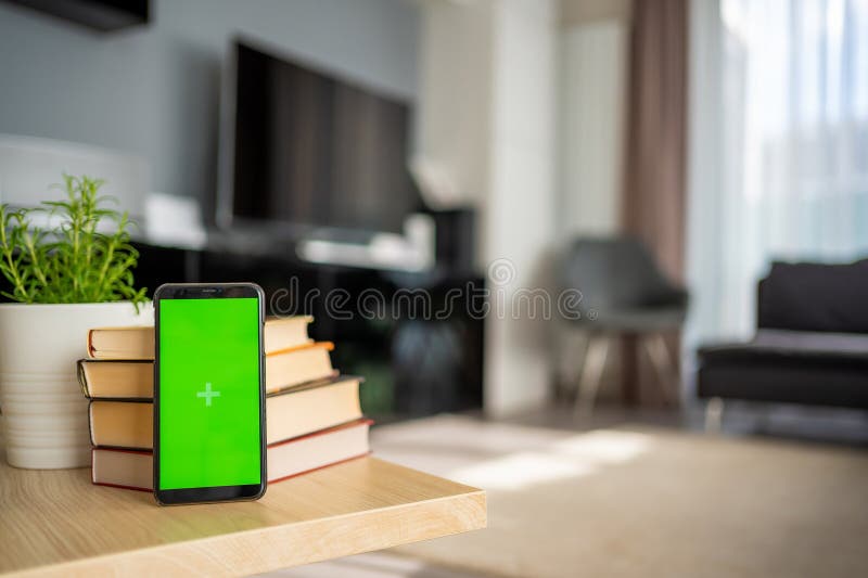 Digital detox concept. In the foreground is a smartphone with green chroma key screen. High quality photo. Digital detox concept. In the foreground is a smartphone with green chroma key screen. High quality photo