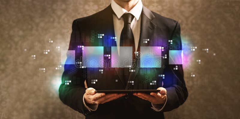 Digital square boxes with businessman holding a tablet computer royalty free stock photography Digital square boxes with businessman holding a tablet computer royalty free stock photography