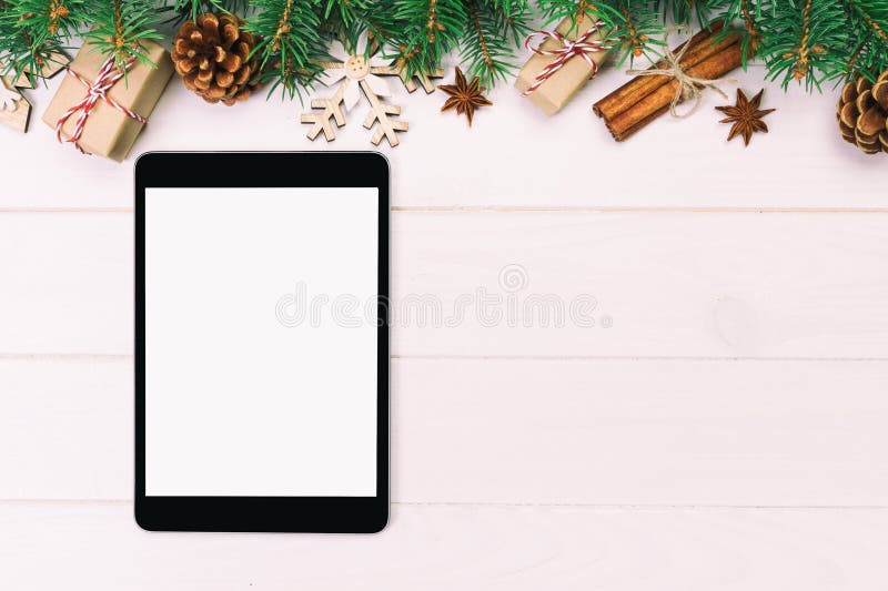 Digital tablet mock up with rustic Christmas wooden background decorations for app presentation. top view with copy space. Toned stock photos Digital tablet mock up with rustic Christmas wooden background decorations for app presentation. top view with copy space. Toned stock photos