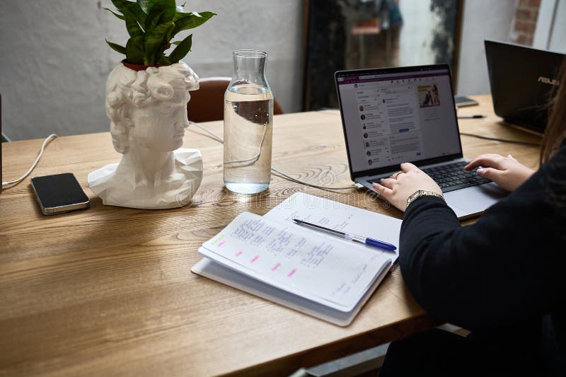 Digital Workspace with Bust Planter, Laptop, Note Taking on Wooden Desk, Inspiring Modern Office Environment Concept stock images