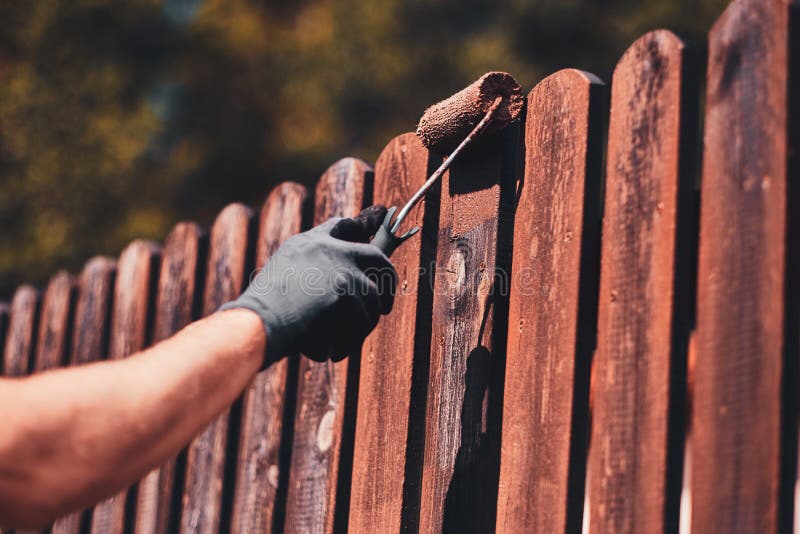 Man Painting a Wooden Picket Fence with Purple Wood Stain and Brush in a  Garden. Stock Photo - Image of natural, nailed: 182923494