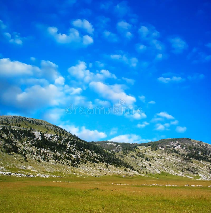 Dinara mountain over blue clouds 1