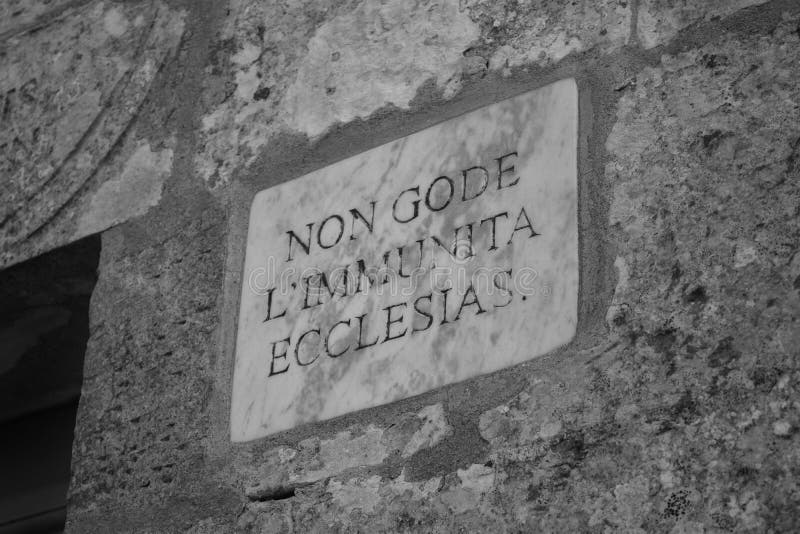 DINGLI, MALTA - Sep 11, 2014: Engraved marble sign on the facade of a chapel, indicating that criminals have no right of sanctuary inside, in Malta. Signs made by Order of St John. DINGLI, MALTA - Sep 11, 2014: Engraved marble sign on the facade of a chapel, indicating that criminals have no right of sanctuary inside, in Malta. Signs made by Order of St John