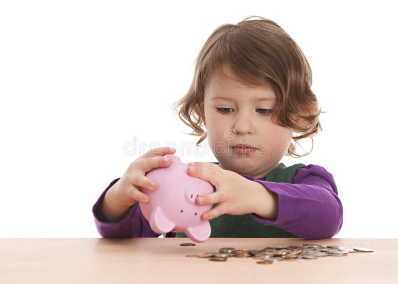 Adorable preschooler trying to get money out of her piggy bank. Isolated on white. Adorable preschooler trying to get money out of her piggy bank. Isolated on white.