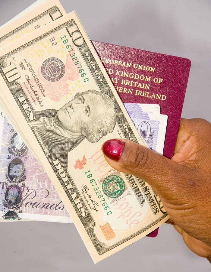 An EU Passport together with dollars and pounds held in a lady's hand ready to go on holiday. An EU Passport together with dollars and pounds held in a lady's hand ready to go on holiday.