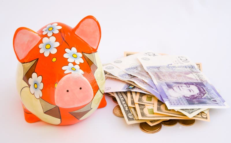 A colorful piggy bank along side which lies pounds and Dollar bills and coins. The concept image is saving money for an enjoyable holiday and all on an isolated plain bright background. A colorful piggy bank along side which lies pounds and Dollar bills and coins. The concept image is saving money for an enjoyable holiday and all on an isolated plain bright background.