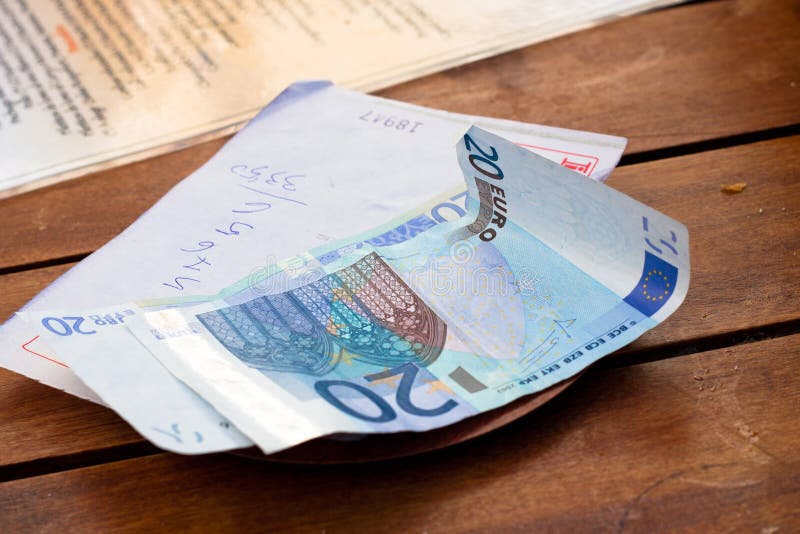 Dining check and Euro banknotes