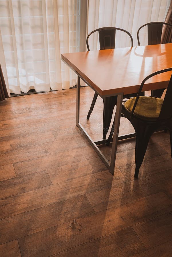 Dining Table in the Cozy Room on Wooden Floor. Stock Photo Image of