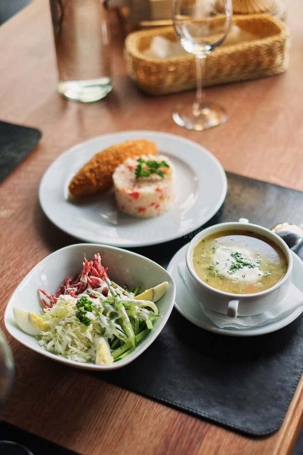 dining table:a plate of soup, risotto with cutlet and vegetable salad royalty free stock photos dining table:a plate of soup, risotto with cutlet and vegetable salad royalty free stock photos
