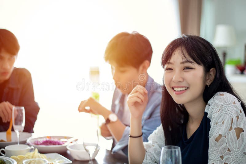 Dinner with Asian Group of Best Friends Enjoying Evening Drinks while