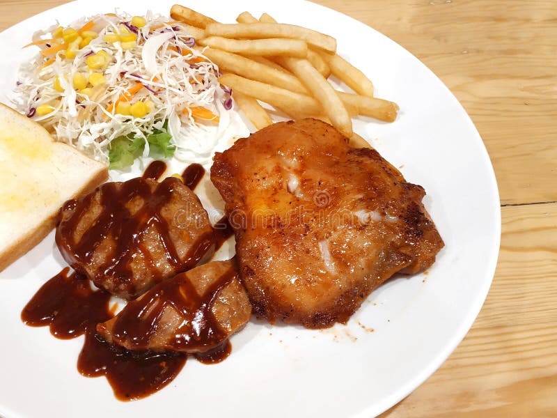 DinnerBBQ pork steak with grilled chicken steak at a shop in Thailand royalty free stock photos DinnerBBQ pork steak with grilled chicken steak at a shop in Thailand royalty free stock photos