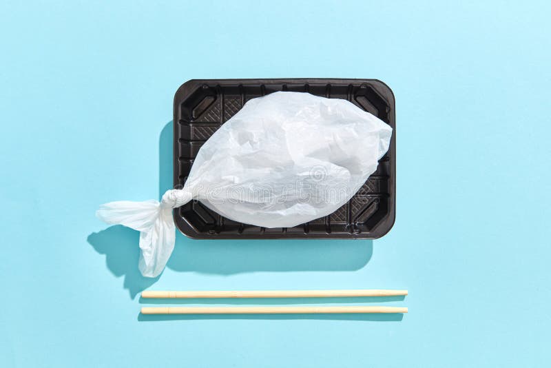 Dinner container with fish from plastic bag served wooden chopsticks. stock images Dinner container with fish from plastic bag served wooden chopsticks. stock images