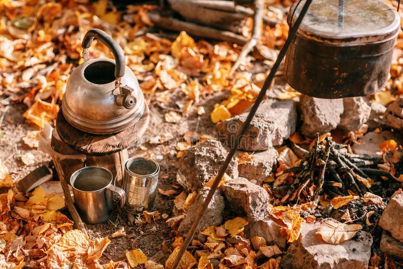 Dinner cooks in a large pot over an open fire. autumn forest royalty free stock photo Dinner cooks in a large pot over an open fire. autumn forest royalty free stock photo