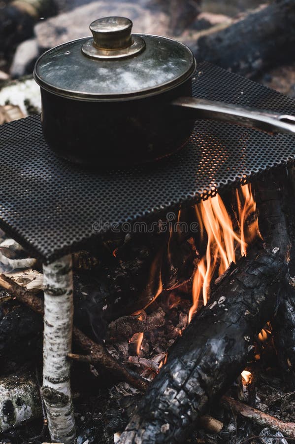 Dinner is Prepared in a Saucepan on an Improvised Stove. Stock Photo