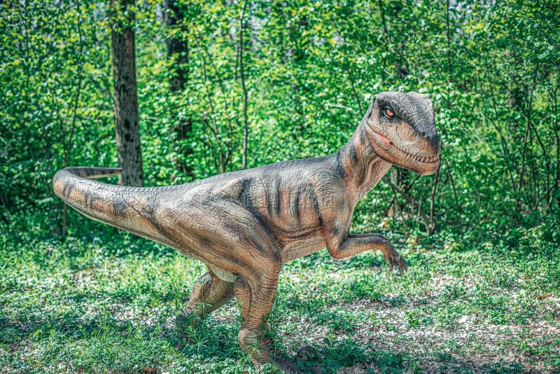 Dinosaur in the jungle. A huge dinosaur against the background of a prehistoric forest.