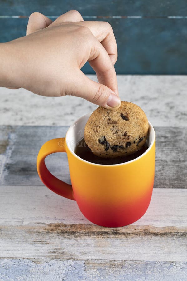 Dipping a cookie into tea stock image. Image of pastry 189276377