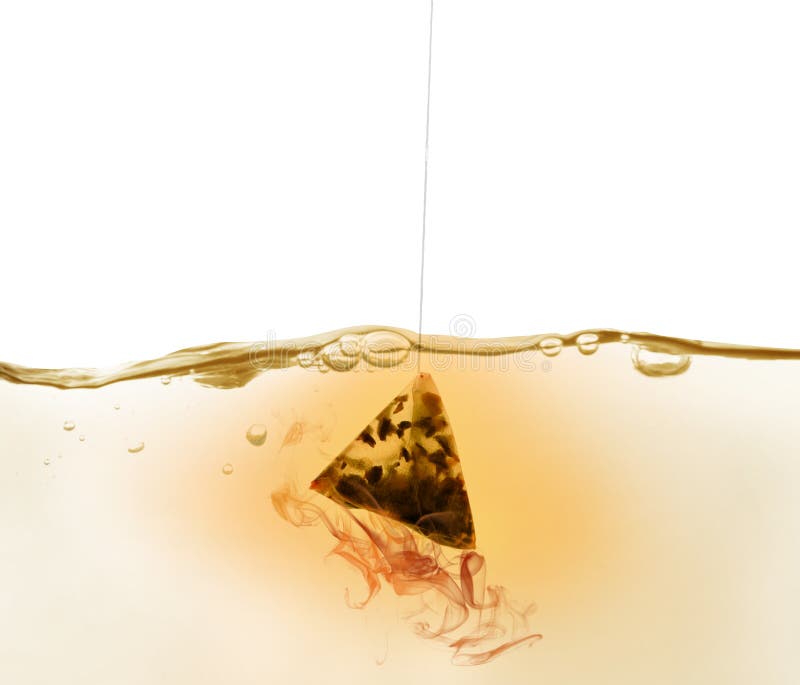 Dipping of Tea Bag into Hot Water Against White Background Stock Photo