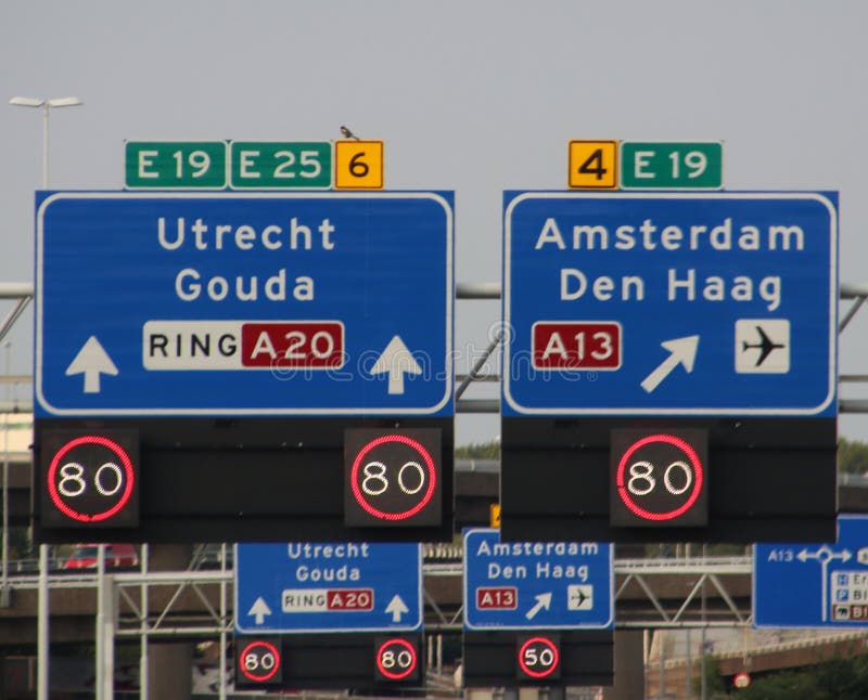 Direction and mandatory speed sign above motorway A20 with split between Rotterdam and to The Hague and Amsterdam via A13 stock image Direction and mandatory speed sign above motorway A20 with split between Rotterdam and to The Hague and Amsterdam via A13 stock image
