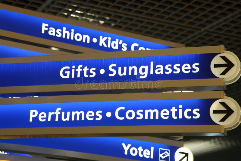 Directions pointing to different stores in the airport