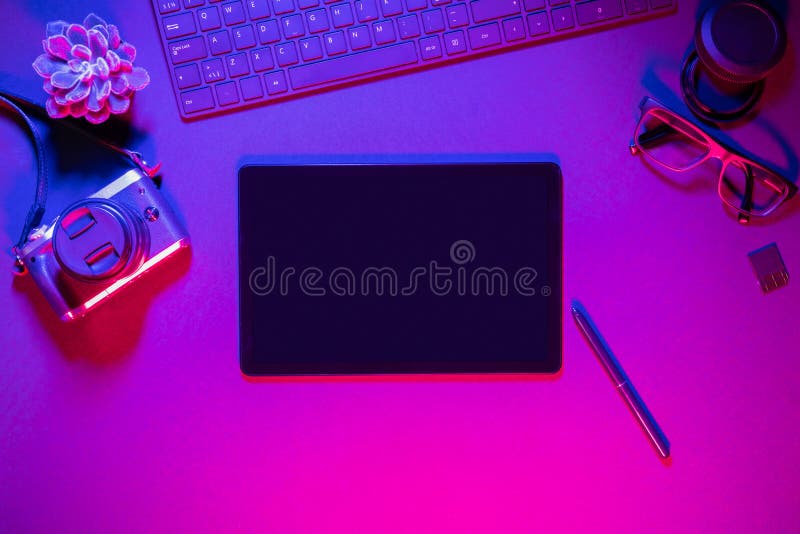 Directly above shot of computer keyboard with camera and digital tablet on illuminated table stock photos
