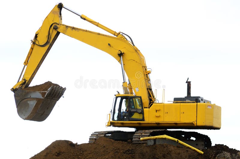 A large track hoe exchavator working on removing a dirt hill for a new road project in Oregon. Track hoe construction excavator stock images, royalty-free photos and pictures