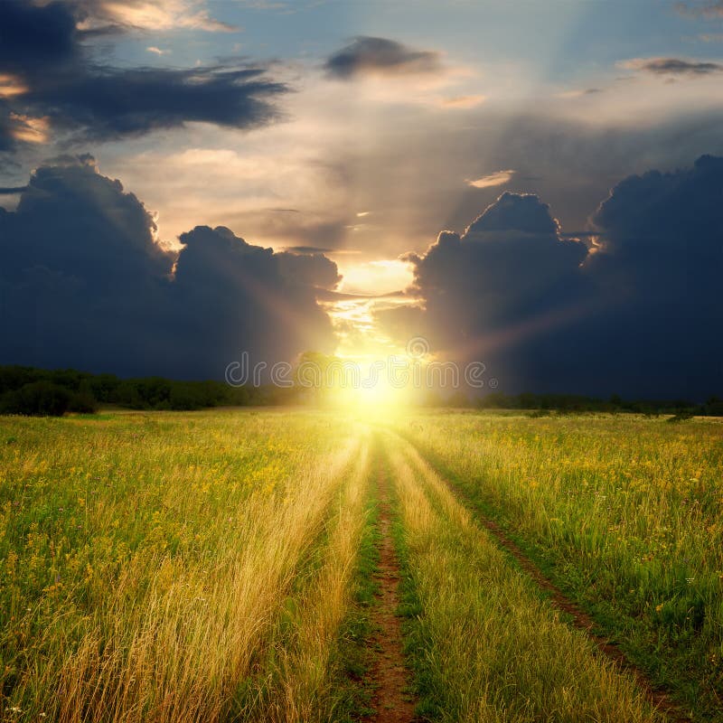 Dirt field road and sunset