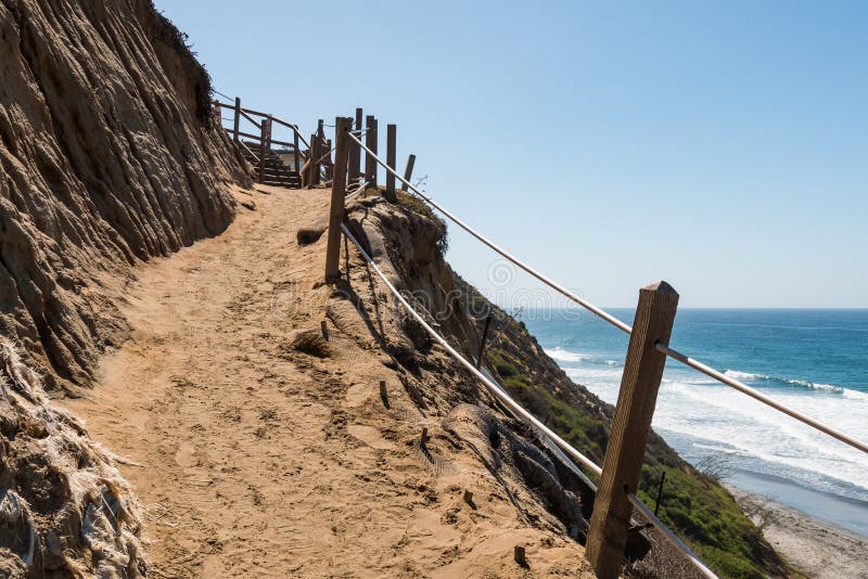 A dirt path on the side of a cliff headed down toward the beach at Beacon`s Beach in Encinitas, California. A dirt path on the side of a cliff headed down toward the beach at Beacon`s Beach in Encinitas, California.