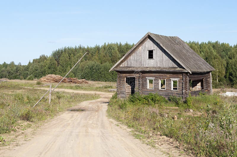 Dirt road and abandoned wooden house