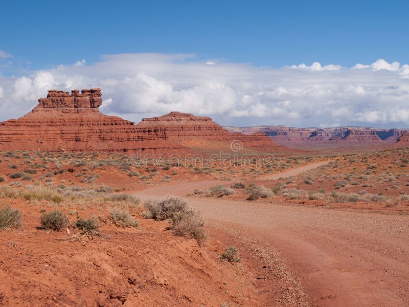 Dirt road into desert landscape royalty free stock photography